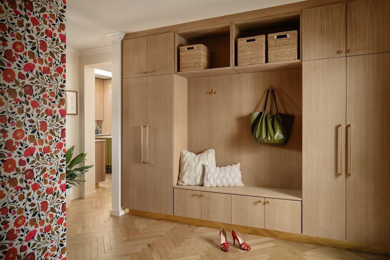 Stylish entryway with wooden storage and decorative elements.