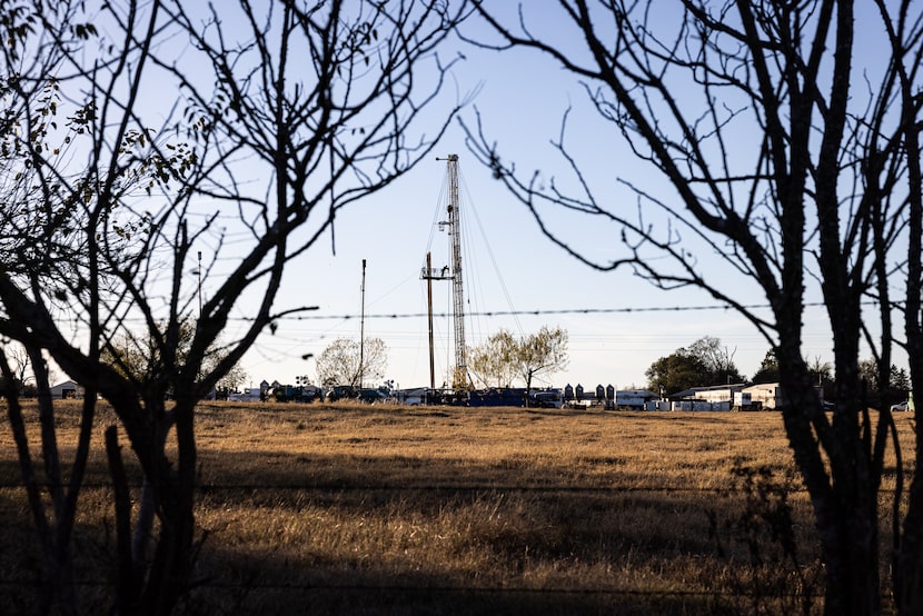A derrickman guides pipes into a block while drilling a direct lithium extraction test well...