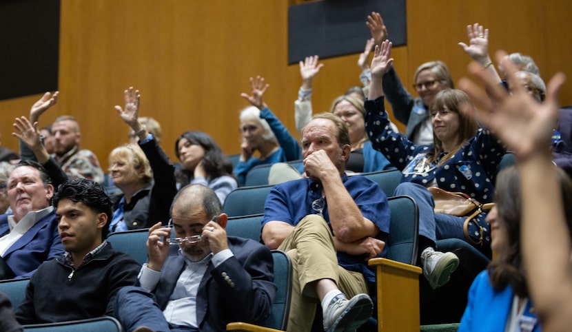 Members of the audience show support to a speaker who spoke in favor of keeping Dallas City...