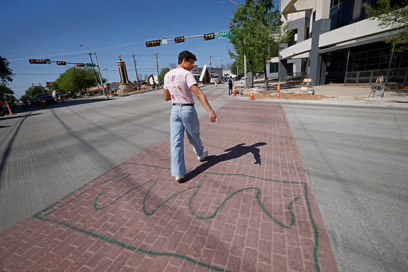 Mason Whiteside of Carrollton shows his artwork that he painted on an Oak Lawn crosswalk...