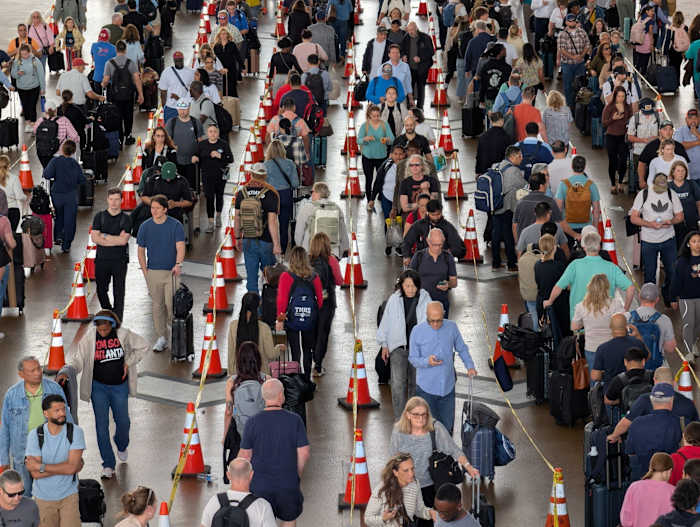 Don’t pay someone to wait in TSA line for you, Bush Airport announcement says