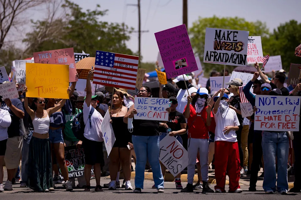 Protesters in El Paso held signs and American flags during a No Kings demonstration at Edgemere Park on Saturday, June 14, 2025. The event was part of a national movement opposing authoritarianism and recent immigration enforcement actions.