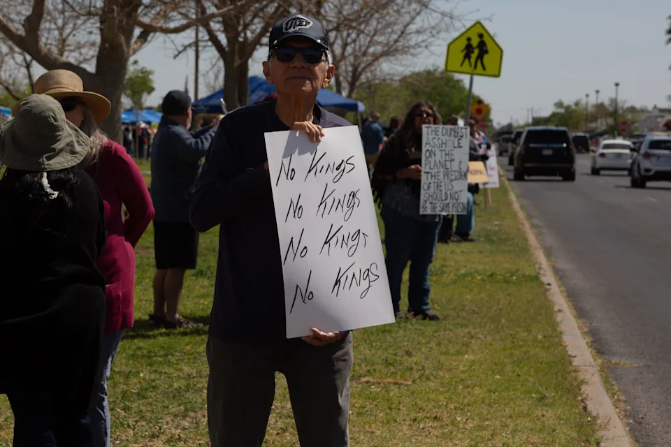 A man holds up a sign that reads "no kings" over and over during the third "No Kings" protest against President Donald Trump on March 28, 2026, in El Paso, Texas.