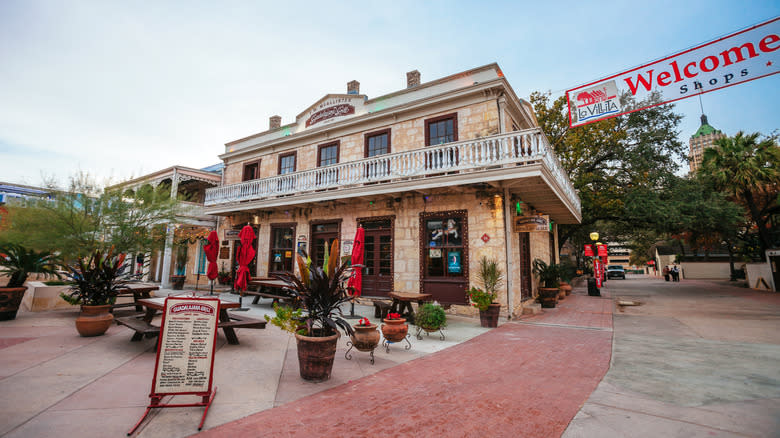 Historic building and banner at entrance of La Villita in San Antonio, Texas
