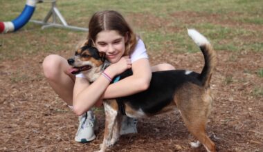 girl hugging dog