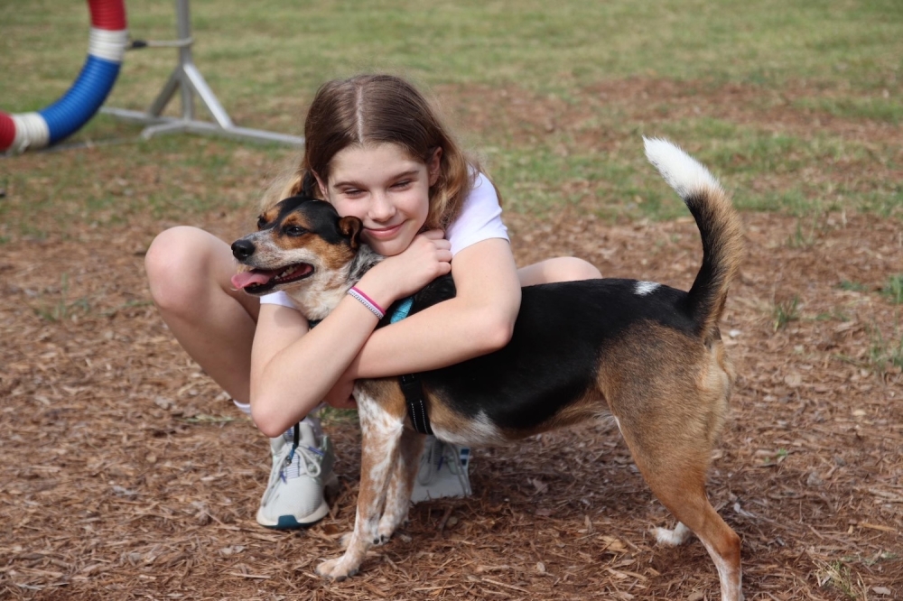 girl hugging dog