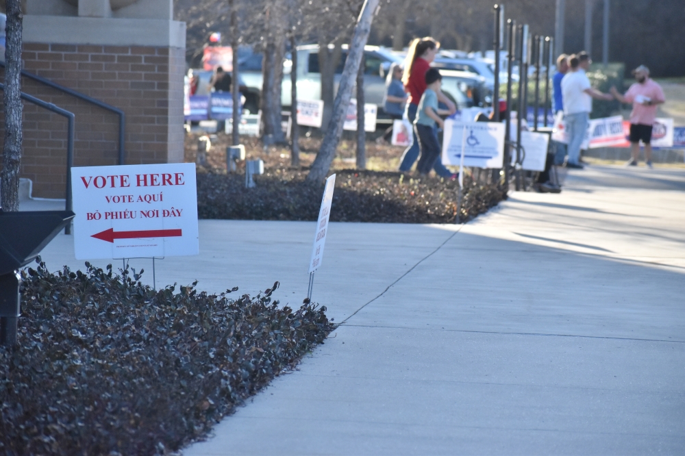 Tarrant County voters walk outside of a polling place for the March 3 primary election.