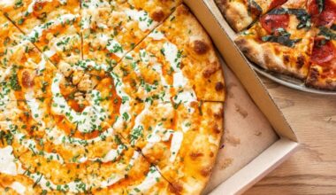 A buffalo chicken pizza in a box from Zalat Pizza.