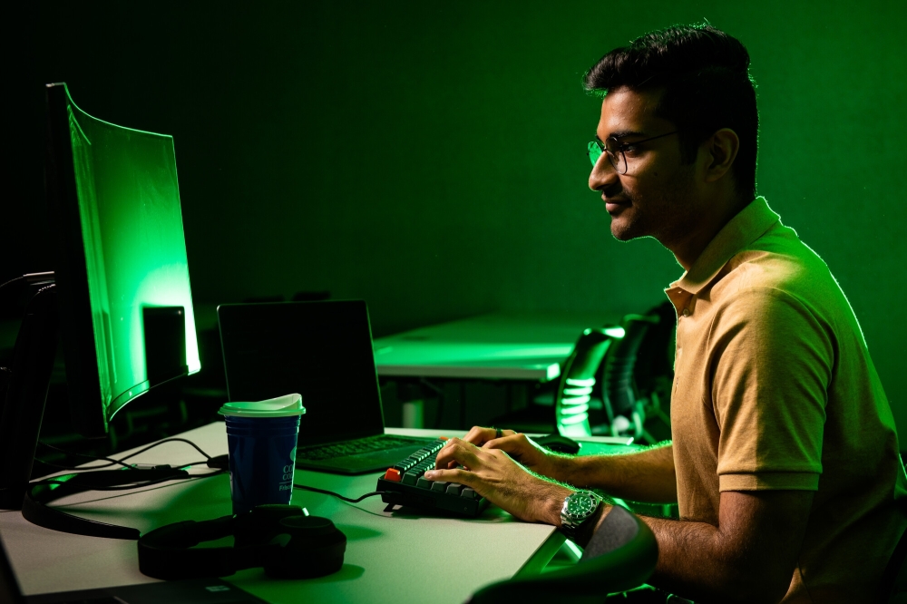 student typing on computer
