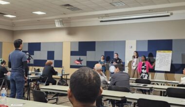 A resident speaks to a representative from the Houston Police Department about concerns of safety and security at their apartment during the apartment inspection ordinance community meeting. (Ariel Worthy/Community Impact)