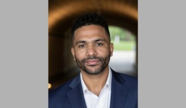 Headshot of man in navy suit and white dress shirt