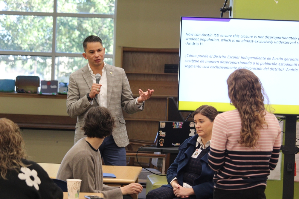 The superintendent speaks to parents at a meeting