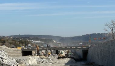 excavators working under bridge