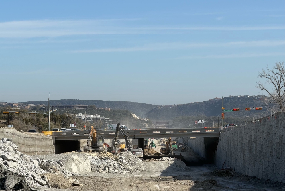 excavators working under bridge