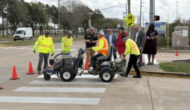 Harris County Precinct 4 Commissioner Lesley Briones watches crews complete crosswalk work after a press conference for the Crosswalks 4 Precinct 4 project March 6. (Brad Dountz/Community Impact)