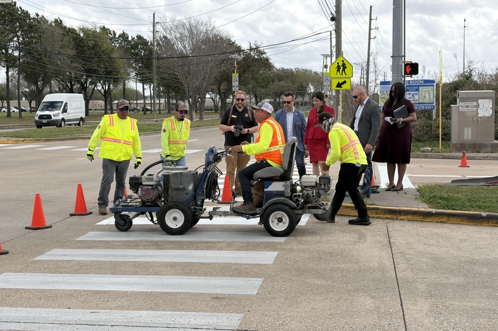 Harris County Precinct 4 Commissioner Lesley Briones watches crews complete crosswalk work after a press conference for the Crosswalks 4 Precinct 4 project March 6. (Brad Dountz/Community Impact)