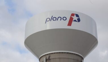 A water tower with the city of Plano logo