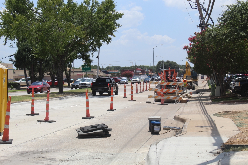 Cars driving between cones on Custer Road