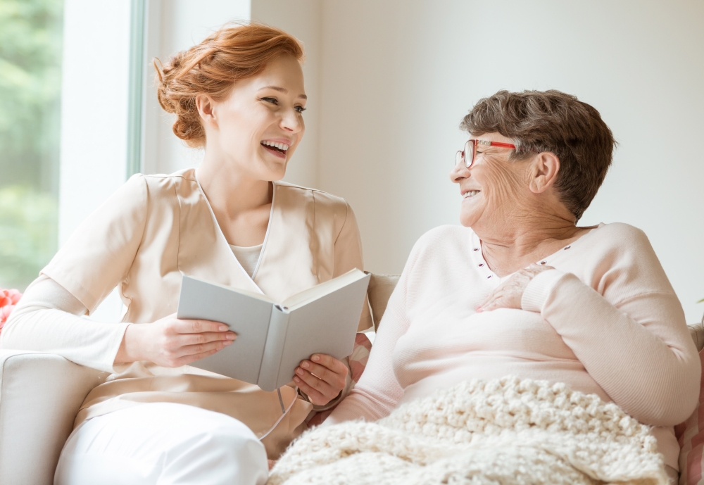 staff member reading to resident