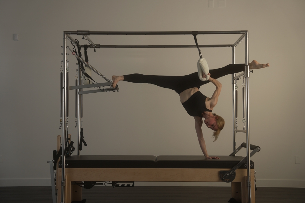 Olga Roberts (pictured on a Pilates reformer) opened a new studio in downtown Austin in January. (Courtesy Olga Roberts — Body Intelligence Pilates)