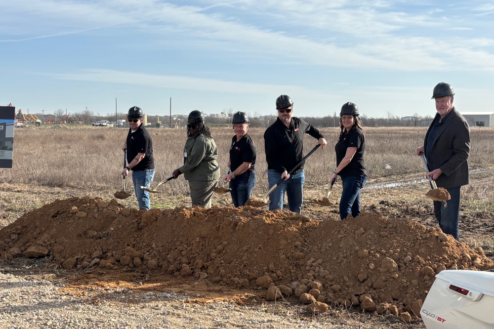 Company officials shovel dirt at the National Powersports Auctions groundbreaking Feb. 19.