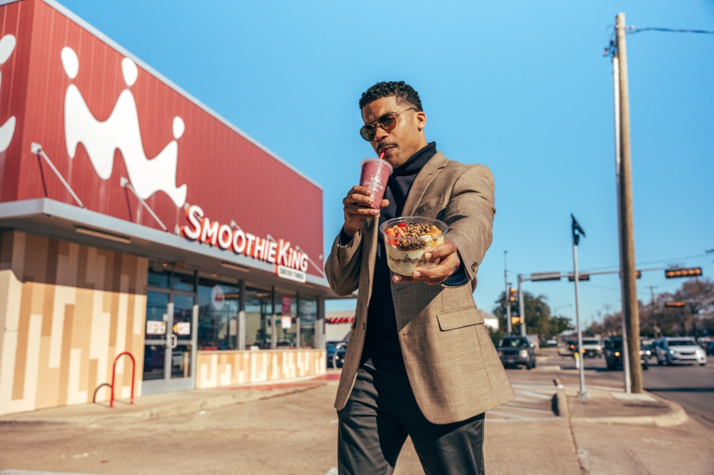 Man with smoothie and yogurt bowl