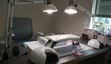 Two desk lamps shining on a nail salon manicure station.