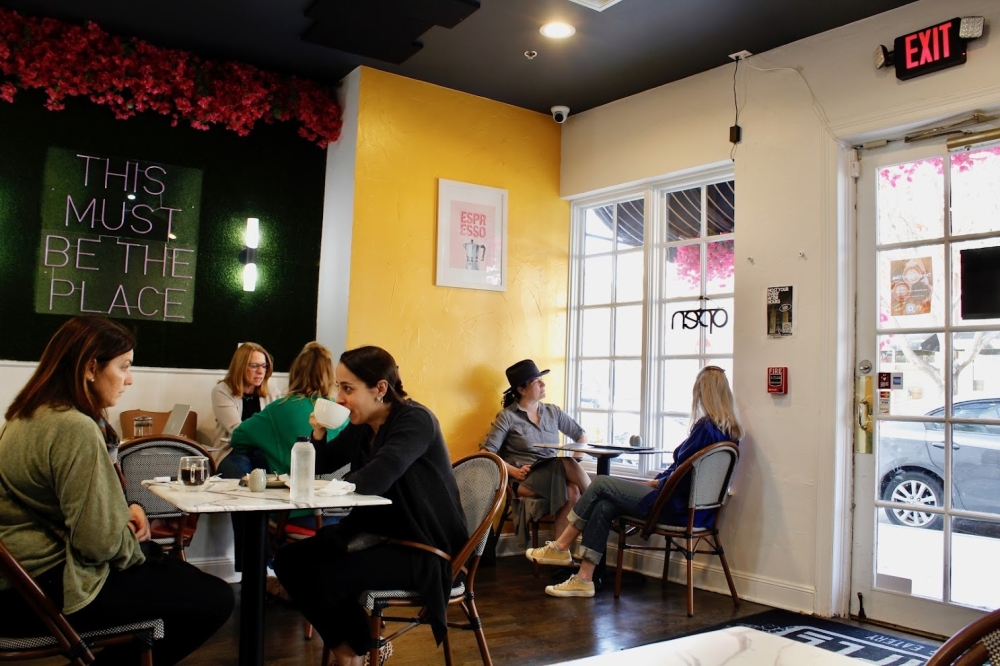 Customers eat and drink within Temple Coffee in The Village.