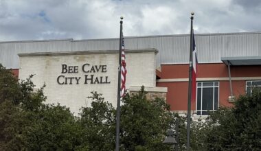 exterior shot of Bee Cave city hall with texas and U.S. flags