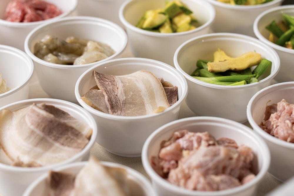 iWok staff prepare the ingredients before the robotic system cooks the food. (Courtesy iWok)