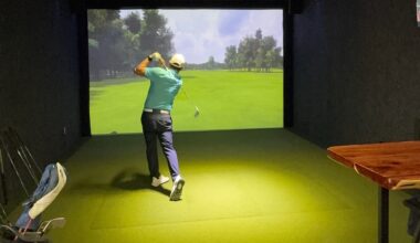 Man golfing indoors