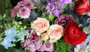 Flower arrangement featuring purple, pink, blue and red flowers.