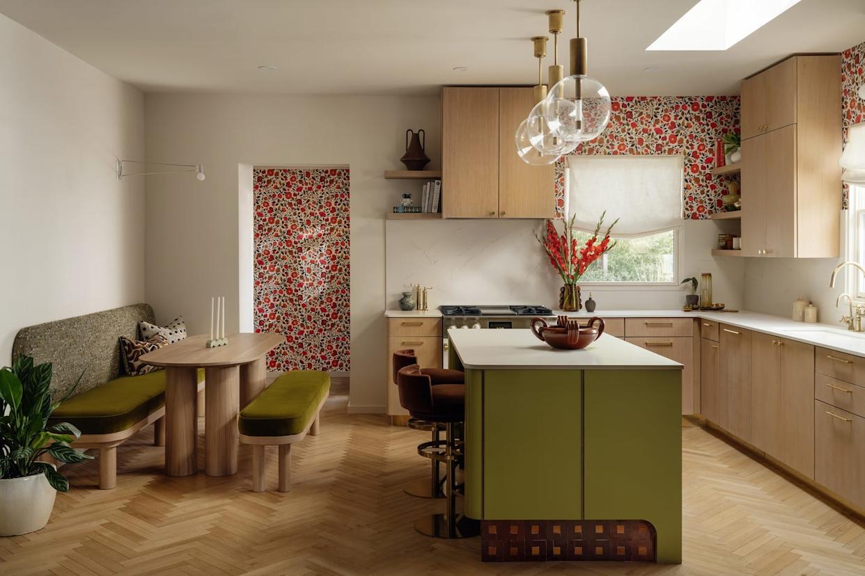 Modern kitchen with a dining area, cabinetry, and decorative elements.