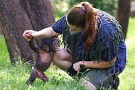 Four-month-old Makutu tries to reach back after he was brought down to the ground by Sara...