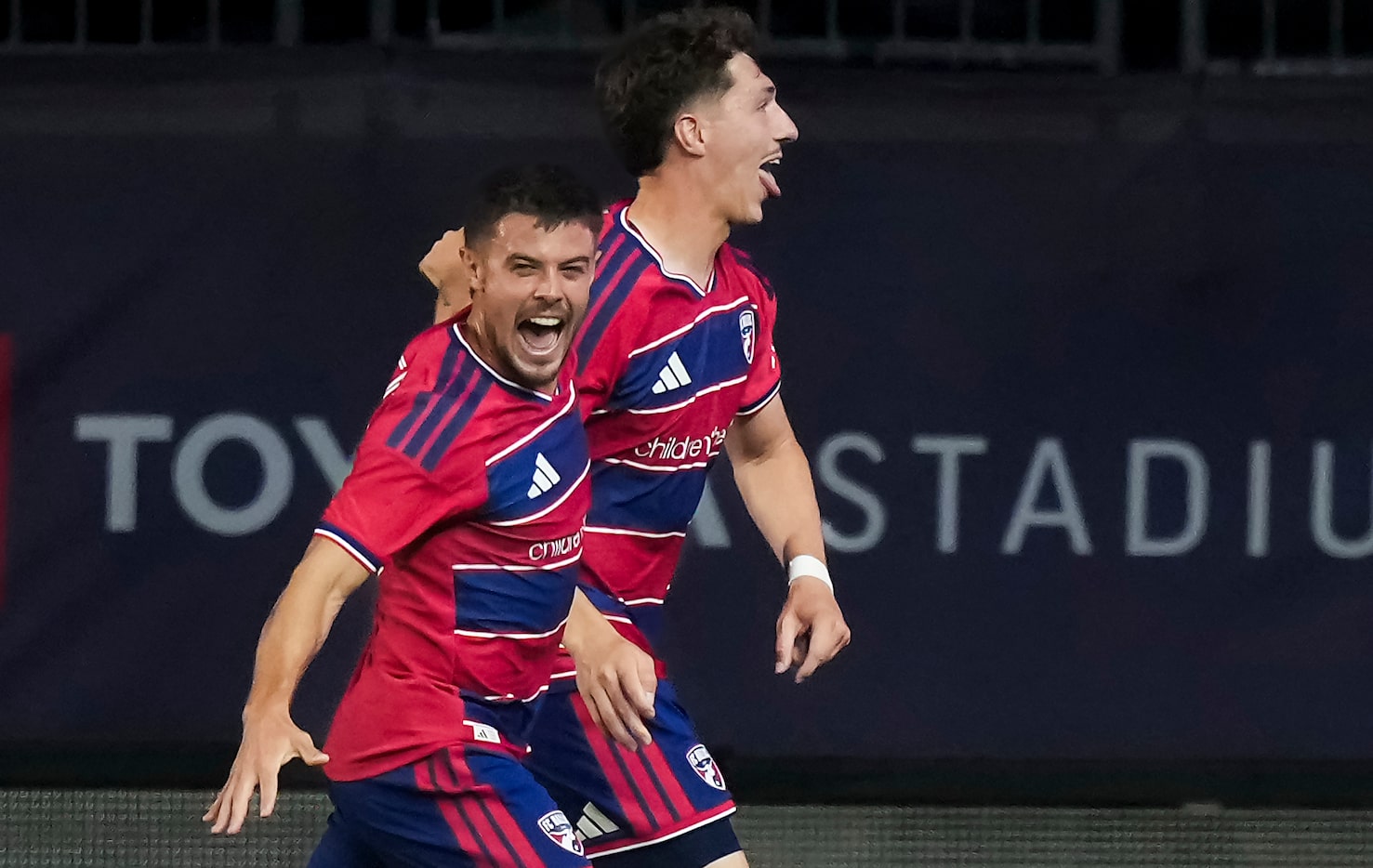 FC Dallas forward Logan Farrington (23) celebrates a goal midfielder Joaquín Valiente (21)...