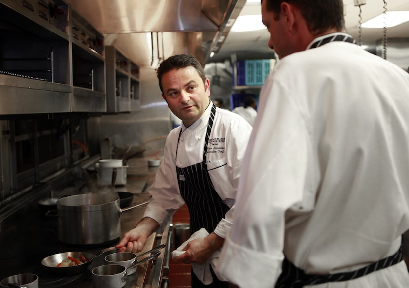 Bruno Davaillon talks to chef de cuisine Jason Maddy (right) while Davaillon prepares a dish...