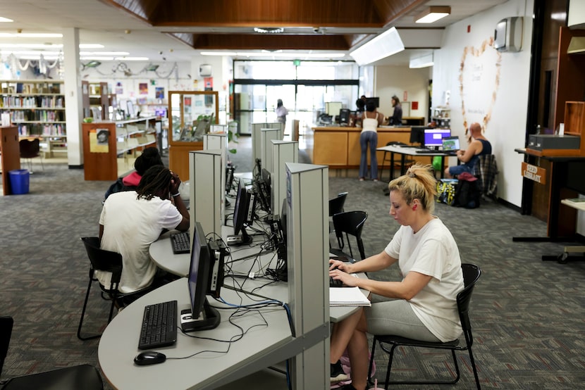 People work at the computer station in the Martin Luther King Jr. Branch Library,  on...