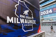 People walk past the Fiserv Forum ahead of the 2024 Republican National Convention,...