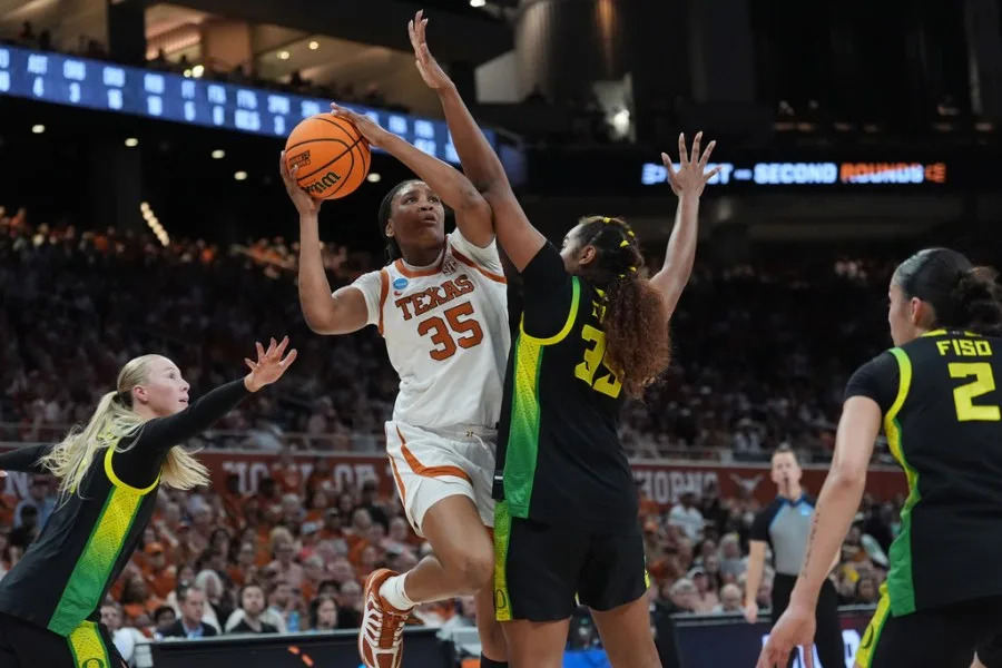 Texas forward Madison Booker (35) drives to the basket against Oregon forward Ehis Etute (35) during the second half in the second round of the NCAA college basketball tournament, Sunday, March 22, 2026, in Austin, Texas. (AP Photo/Eric Gay)