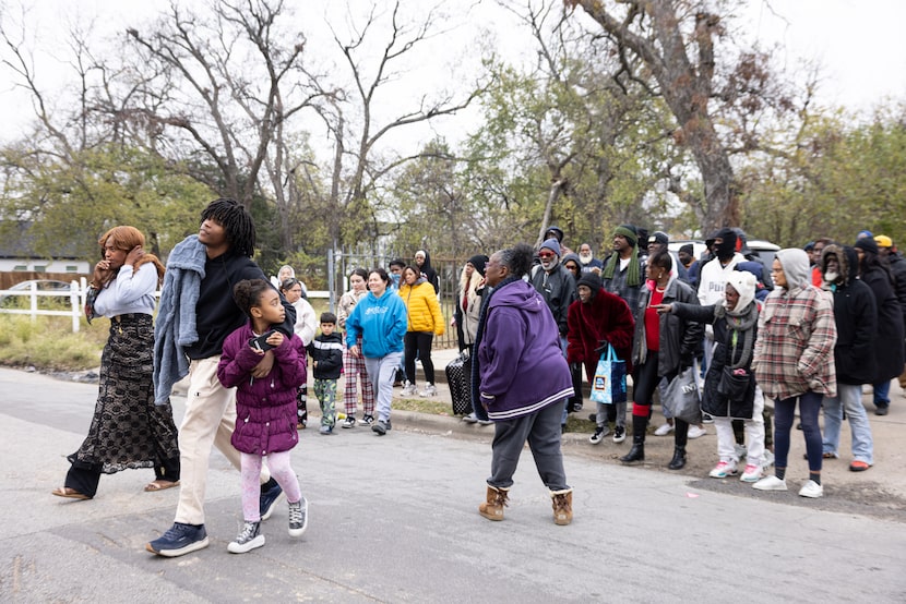 Rhonda Willingham organizes a crowd of Mill City residents and homeless waiting in the cold...