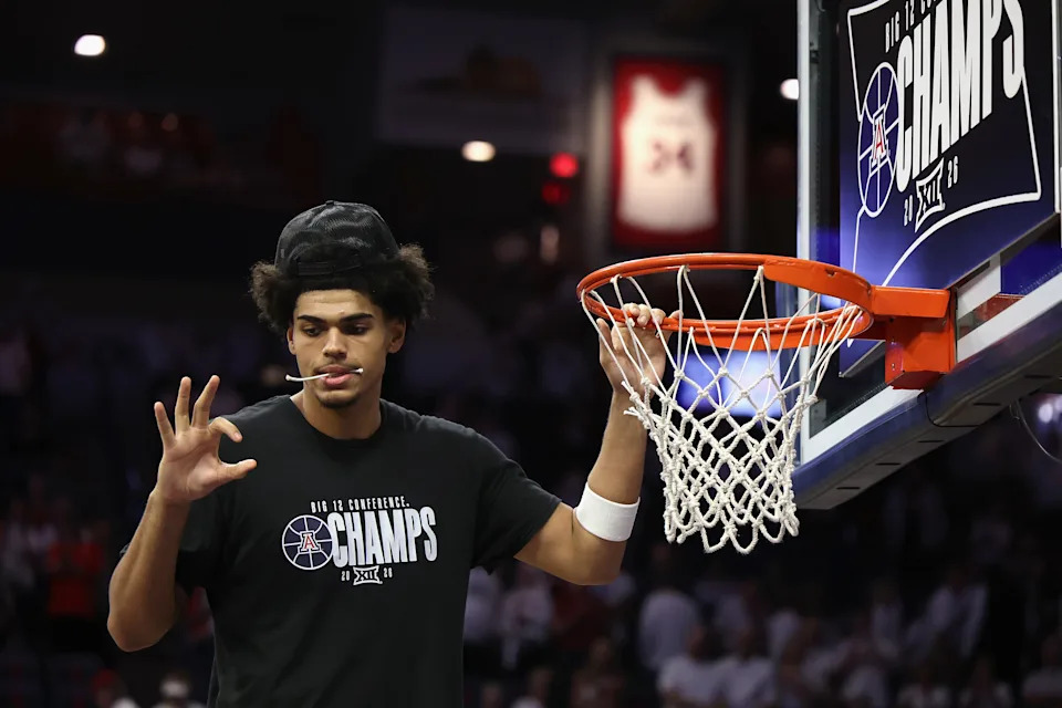 TUCSON, ARIZONA - MARCH 02: Koa Peat #10 of the Arizona Wildcats cuts down the nets as he celebrates winning the Big 12 regular-season title following the NCAAB game Iowa State Cyclones at McKale Center at ALKEME Arena on March 02, 2026 in Tucson, Arizona.  The Wildcats defeated the Hawkeyes 73-57.  (Photo by Christian Petersen/Getty Images)