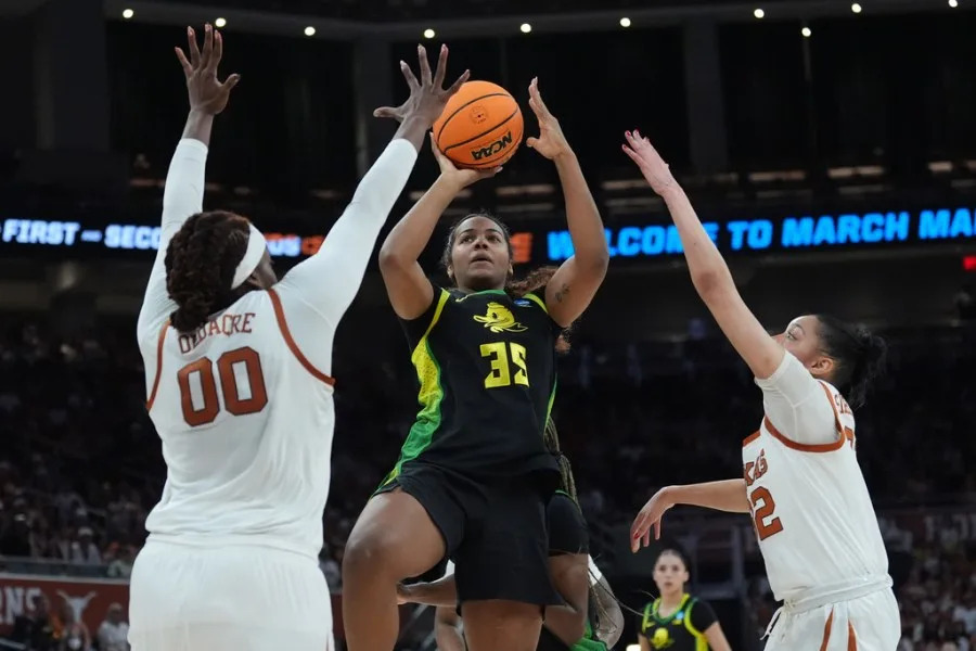 Oregon forward Ehis Etute (35) drives to the basket against Texas center Kyla Oldacre (00) during the first half in the second round of the NCAA college basketball tournament, Sunday, March 22, 2026, in Austin, Texas. (AP Photo/Eric Gay)