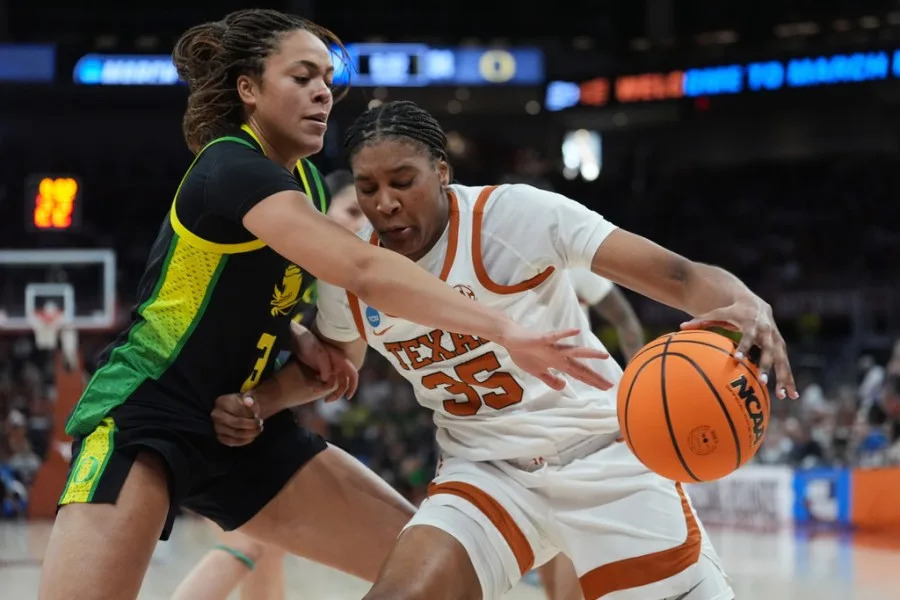 Texas forward Madison Booker (35) drives against Oregon guard Sofia Bell (3) during the second half in the second round of the NCAA college basketball tournament, Sunday, March 22, 2026, in Austin, Texas. (AP Photo/Eric Gay)