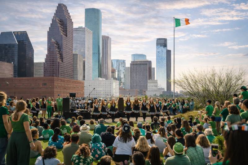 Image shows an Irish dance group performing at POST SKylawn in Houston to a crowd.