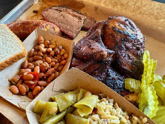 Smoked chicken with brisket, sausage and sides at The Original Roy Hutchins BBQ in Trophy Club, as seen May 4, 2024.