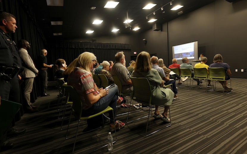 Concerned residents of District 11 listen to a city staff assembled presentation on the...