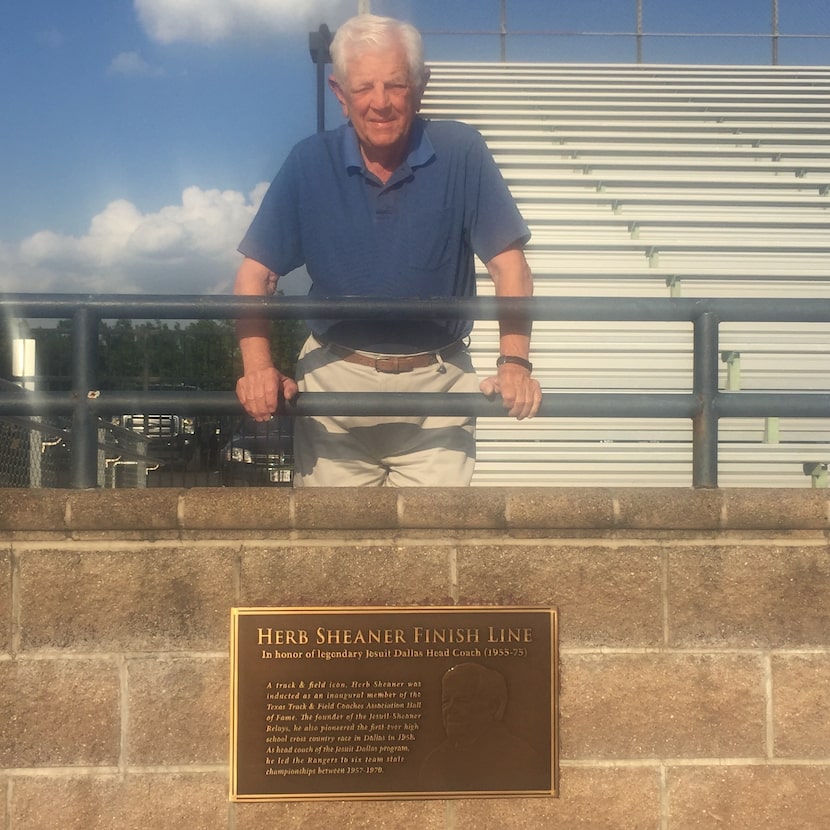 Herb Sheaner stands at the Jesuit track, where the finish line was dedicated to him.