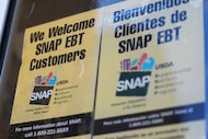 FILE - A SNAP EBT information sign is displayed outside of a convenience store in Baltimore,...