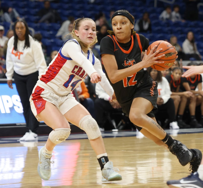 Lancaster guard Journee Hampton (12) drives against the defense of Austin Westlake guard...