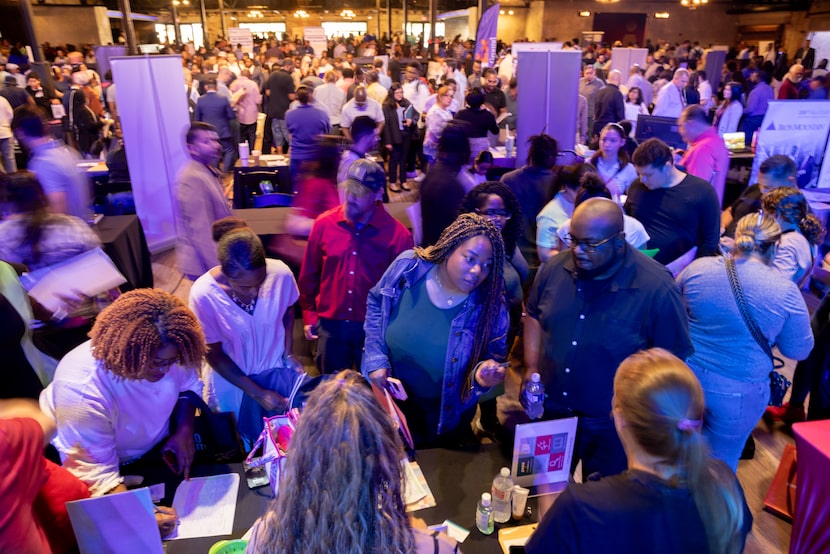 Claris Ngoma, center, and husband Allen Ngoma, center right, check out the Carter BloodCare...